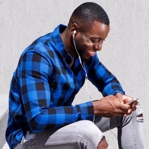 handsome man smiling with headphones and smart pho 2021 08 26 23 05 28 utc